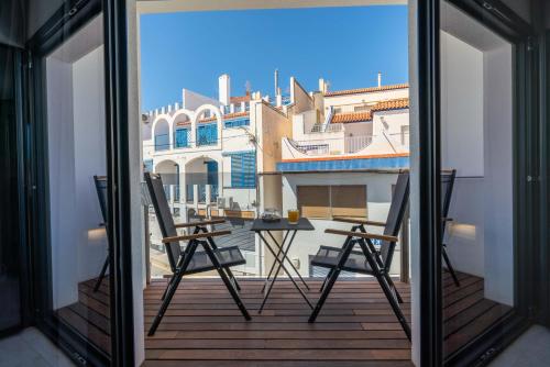 a view from a balcony with two chairs and a table at Hotel Cala Arena in San José