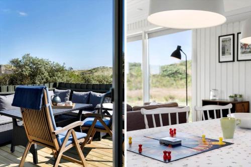 a living room with a table and chairs and a patio at BL1326-Saltum-Svendborgvej-19 in Saltum