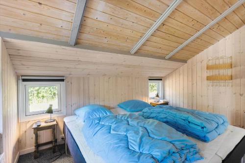 a large bed in a room with a wooden ceiling at BL1374-Saltum-Sydvestpassagen-8 in Saltum