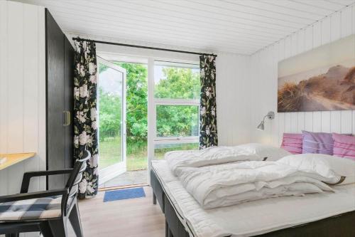 a bedroom with two beds and a window at BL1487-Saltum-Brune-Banke-7 in Saltum