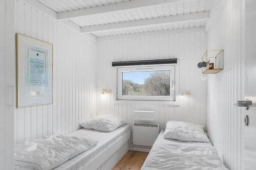 a white room with two beds and a window at BL738-Saltum-Graabakken-53 in Saltum