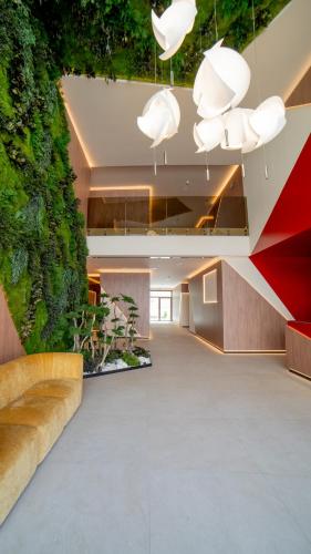 an office lobby with a green wall at Olea Suites in Alcalá del Júcar