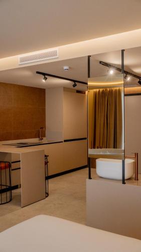 a room with a kitchen with a sink and a counter at Olea Suites in Alcalá del Júcar