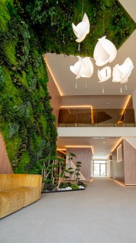 a green wall in the lobby of a building at Olea Suites in Alcalá del Júcar