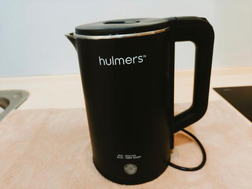 a black mug with the word hunters written on it at SoulHealingPlace Galacity 2BR 2Bed Apartment in Kuching