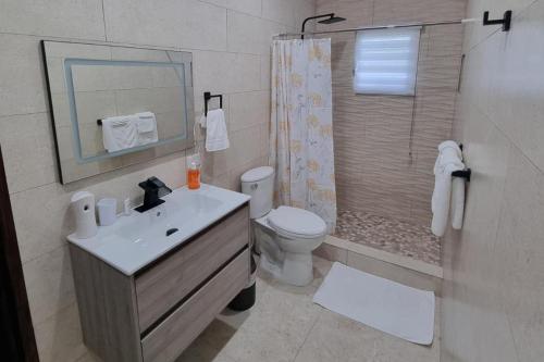 a bathroom with a sink and a toilet and a shower at Condo with Pool - Sleeps 8 & bbq facilities in Philipsburg