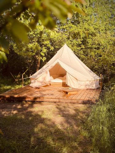 a white tent sitting on a wooden deck at Jelena in Kutná Hora