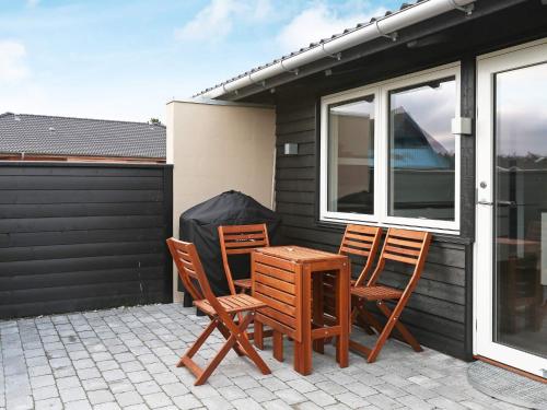 two chairs and a table on a patio at 6 person holiday home in Læsø-By Traum in Læsø