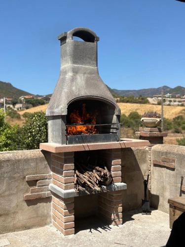a brick oven with a fire inside of it at Casa Vacanza il Mandorlo in Domusnovas