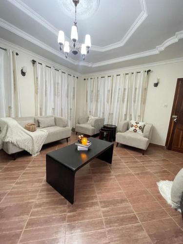 a living room with a couch and a coffee table at Rhovee Arusha in Arusha
