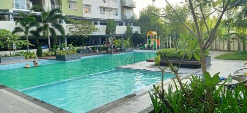 a pool in a building with people in the water at Chic and Affordable Studio in Davao City