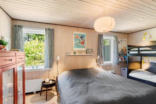 a bedroom with a bed and a bunk bed at BL1666-Saltum-Vikingebanke-5 in Saltum