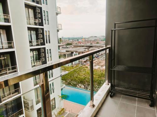 a balcony in a building with a view of a pool at SoulHealingPlace Galacity 2BR 2Bed Apartment in Kuching