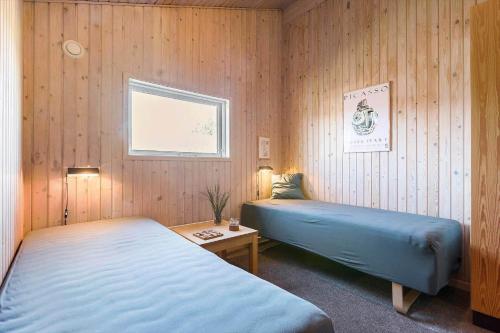 a bedroom with two beds and a table and a window at BL1462-Saltum-Revlingevej-32 in Saltum