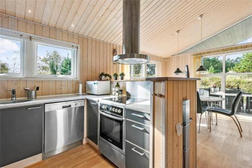 a kitchen with stainless steel appliances and a dining room at BL1678-Pandrup-Hunetorp-Klitvej-1-B in Pandrup