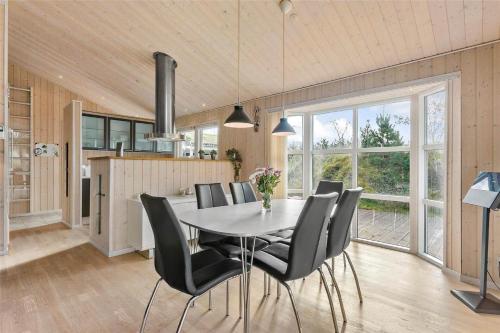 a kitchen and dining room with a table and chairs at BL1678-Pandrup-Hunetorp-Klitvej-1-B in Pandrup