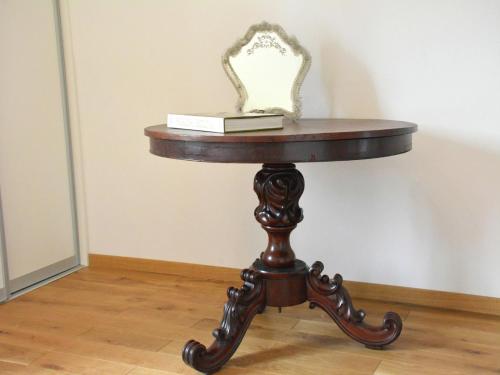 a table with a book and a mirror on it at Farmhouse Retreat, Fernelmont in Forville