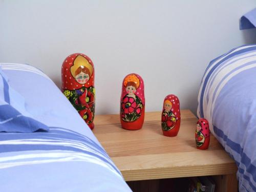 a bed with red slippers on a table next to a bed at Farmhouse Retreat, Fernelmont in Forville