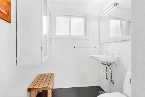 a white bathroom with a toilet and a sink at BL1612-Blokhus-Jens-Baerentsvej-3 in Blokhus