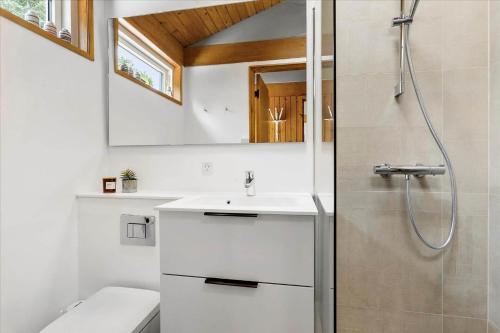 a bathroom with a sink and a shower at BL1728-Blokhus-Kaeruldvej-7 in Blokhus