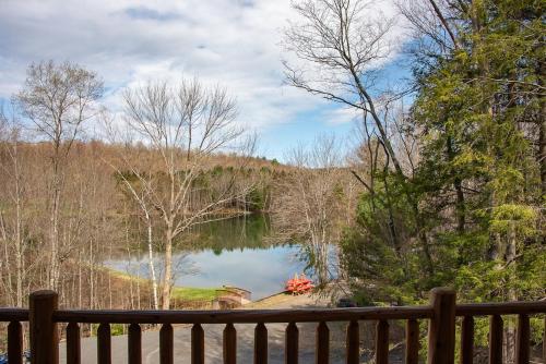 a view of a lake from a wooden fence at Luxury Log Cabin Lakefront, Game room & Fire Pit, in Schenevus