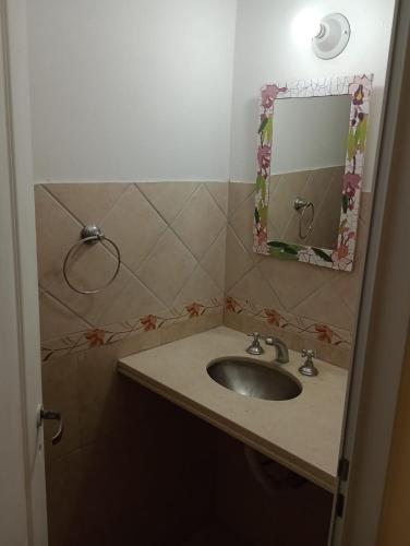 a bathroom with a sink and a mirror at Duplex Rawson in Gualeguaychú