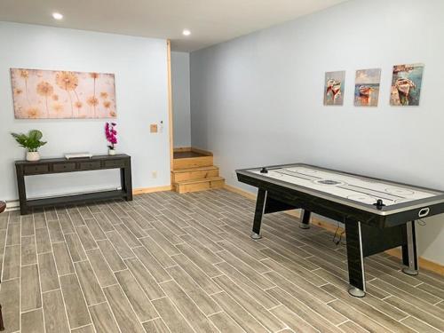 a room with a ping pong table in a room at Luxury Log Cabin Lakefront, Game room & Fire Pit, in Schenevus