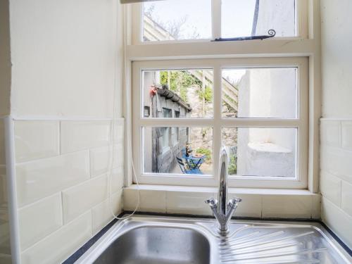 a sink in a kitchen with a window at Kernyck in Port Isaac