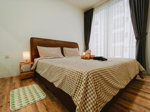 a bedroom with a bed with a teddy bear on it at SoulHealingPlace Galacity 2BR 2Bed Apartment in Kuching