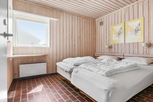 a bedroom with two beds and a window at BL1397-Pandrup-Rodhus-Klitvej-363 in Pandrup