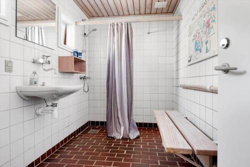 a bathroom with a sink and a shower and a bench at BL1397-Pandrup-Rodhus-Klitvej-363 in Pandrup