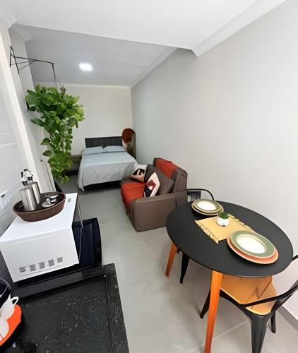 a room with a bed and a couch and a table at Studio kitnet Apartamento Privativo Jundiai 03 in Jundiaí