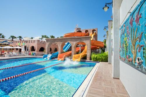 a pool at a resort with a water slide at Aydinbey King's Palace & Spa - Ultra All Inclusive in Side