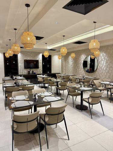 a restaurant with tables and chairs in a room at George Residence TLC in Lekki