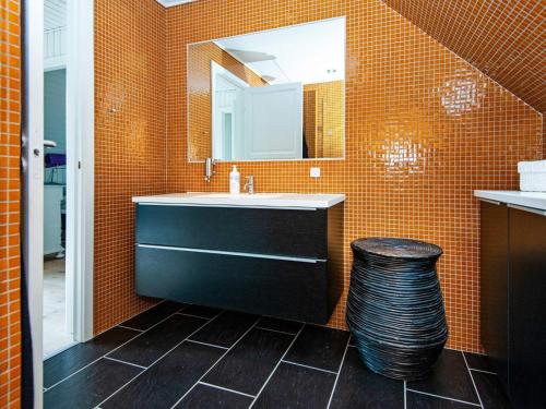 a bathroom with a sink and a mirror at 6 person holiday home in Hemmet-By Traum in Hemmet