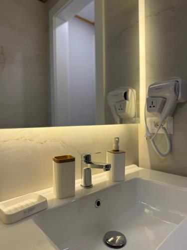 a bathroom with a sink and a mirror at Villa REJA Hamallaj in Draçi
