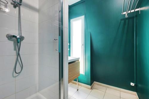 a bathroom with a shower with a glass door at Modern studio - 1P- Canal Saint-Martin in Paris