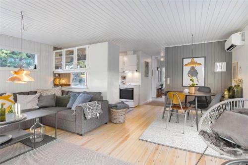 a living room with a couch and a table at BL946-Blokhus-Graevlingevej-8 in Blokhus