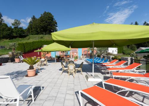 a group of chairs and umbrellas and tables at Hotel Vitaler Landauerhof in Schladming