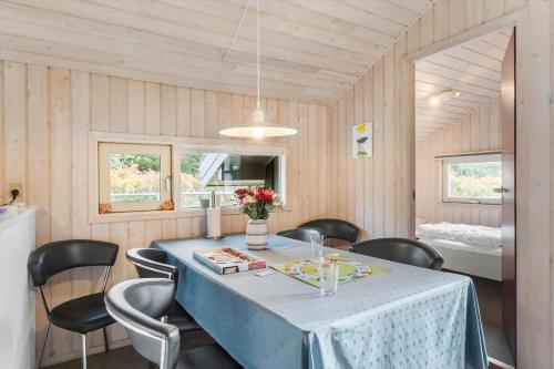 a dining room with a blue table and chairs at BL1255-Pandrup-Rodhusparken-63 in Pandrup