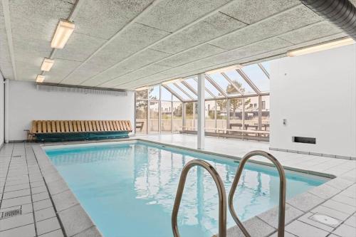 a swimming pool with blue water in a building at BL1538-Blokhus-Ferren-42 in Blokhus