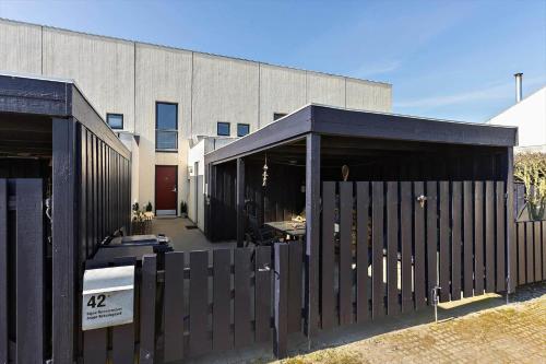 a black fence in front of a building at BL1538-Blokhus-Ferren-42 in Blokhus