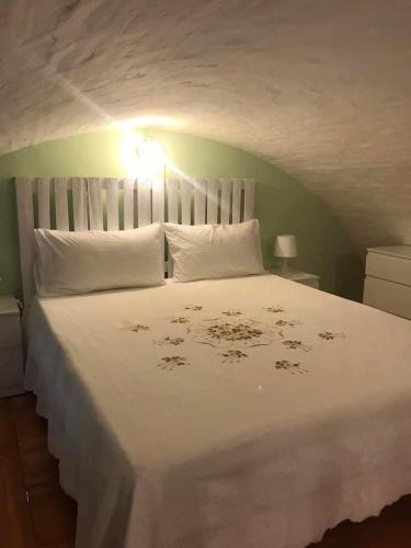 a bedroom with a large white bed with white pillows at La casetta in Serracapriola