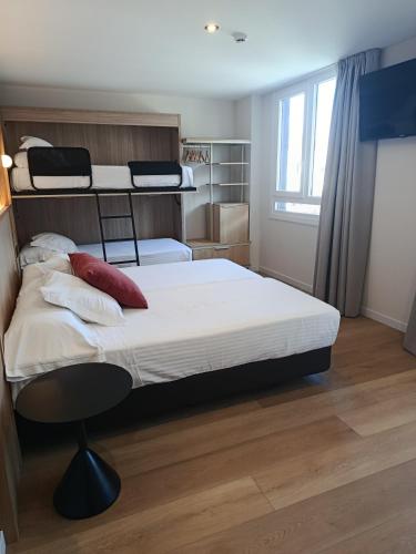 a bedroom with two bunk beds and a chair at Hotel Las Rocas de Isla in Isla