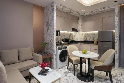 a living room with a couch and a table at Valia Hotel Bangkok in Bangkok