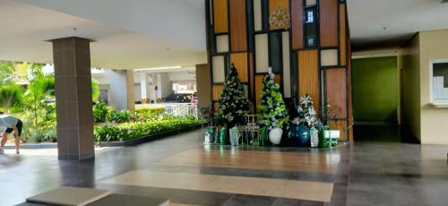 a lobby with christmas trees in a building at Chic and Affordable Studio in Davao City