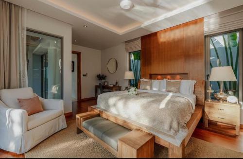 a large bedroom with a large bed and a couch at High quality private villa Phuket in Thalang