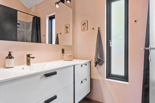 a bathroom with a sink and a mirror at BL1433-Blokhus-Mollevej-11 in Blokhus