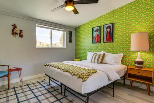 a bedroom with a bed with a green wall at Home with Stunning Mountain Views in Palm Springs! in Palm Springs