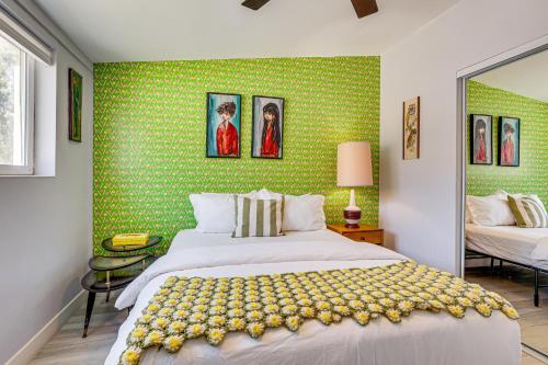 a bedroom with a large bed and a green wall at Home with Stunning Mountain Views in Palm Springs! in Palm Springs